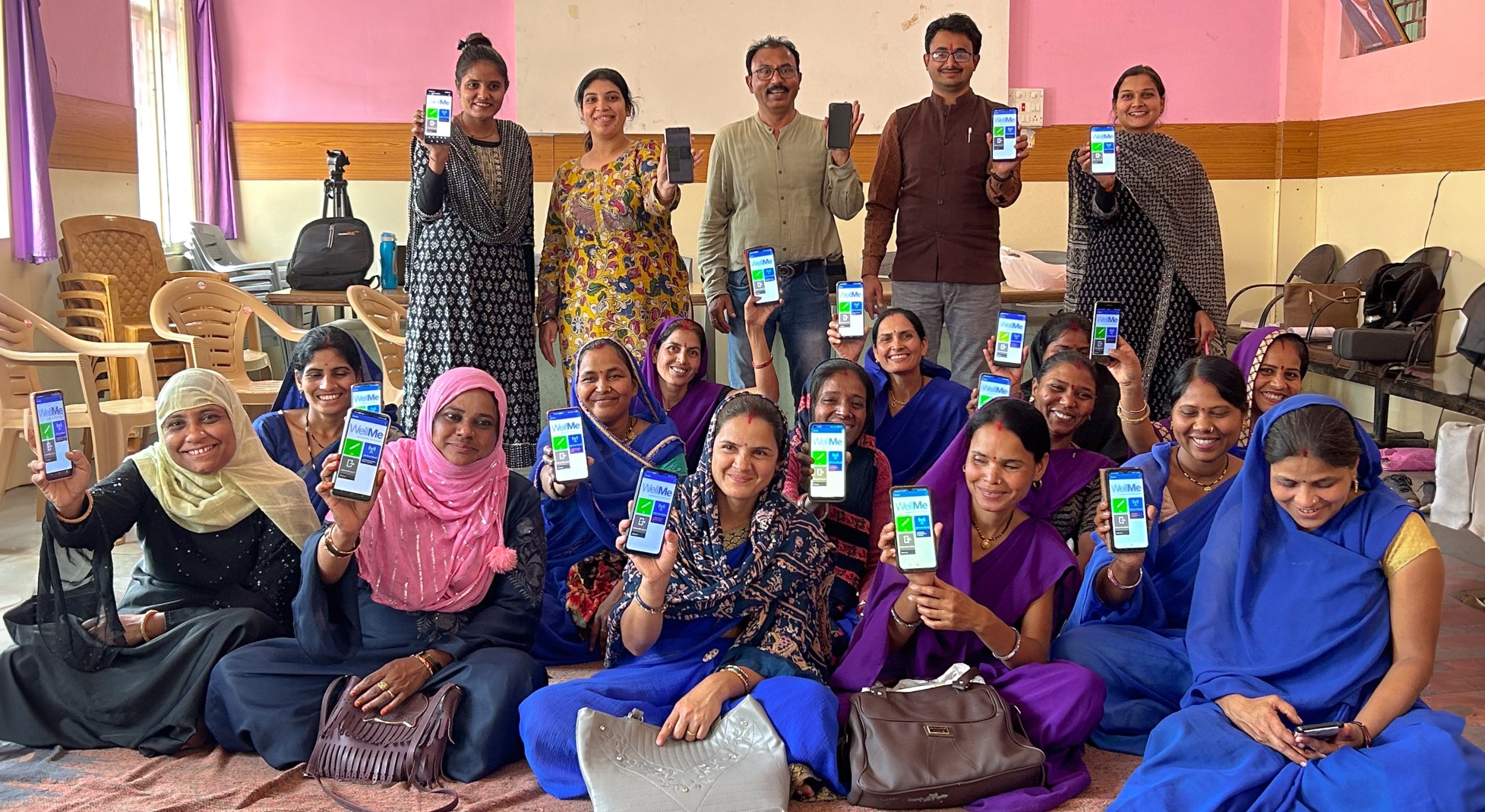 Frontline Workers WellMe Frontline workers holding up their smartphones with CommCare application